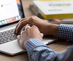 Man scheduling an appointment online with laptop | Mark's Independent Service