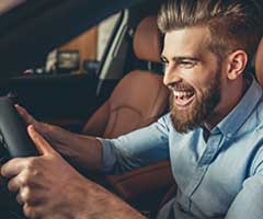 Man smiling as he drives his car | Mark's Independent Service